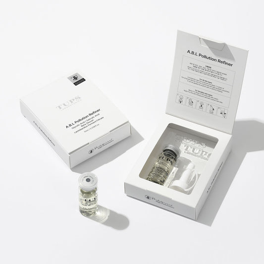 TUPS Laboratories A.B.L Pollution Refiner skincare set, showing an open white box with a vial of clear serum and applicator inside, alongside a closed box and an additional serum vial on a white background