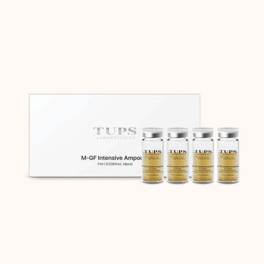 Product image of TUPS Laboratories M-GF Intensive Ampoule set, featuring a white box with the brand logo and four transparent vials containing a golden serum, each labeled with the product name and volume of 7 ml