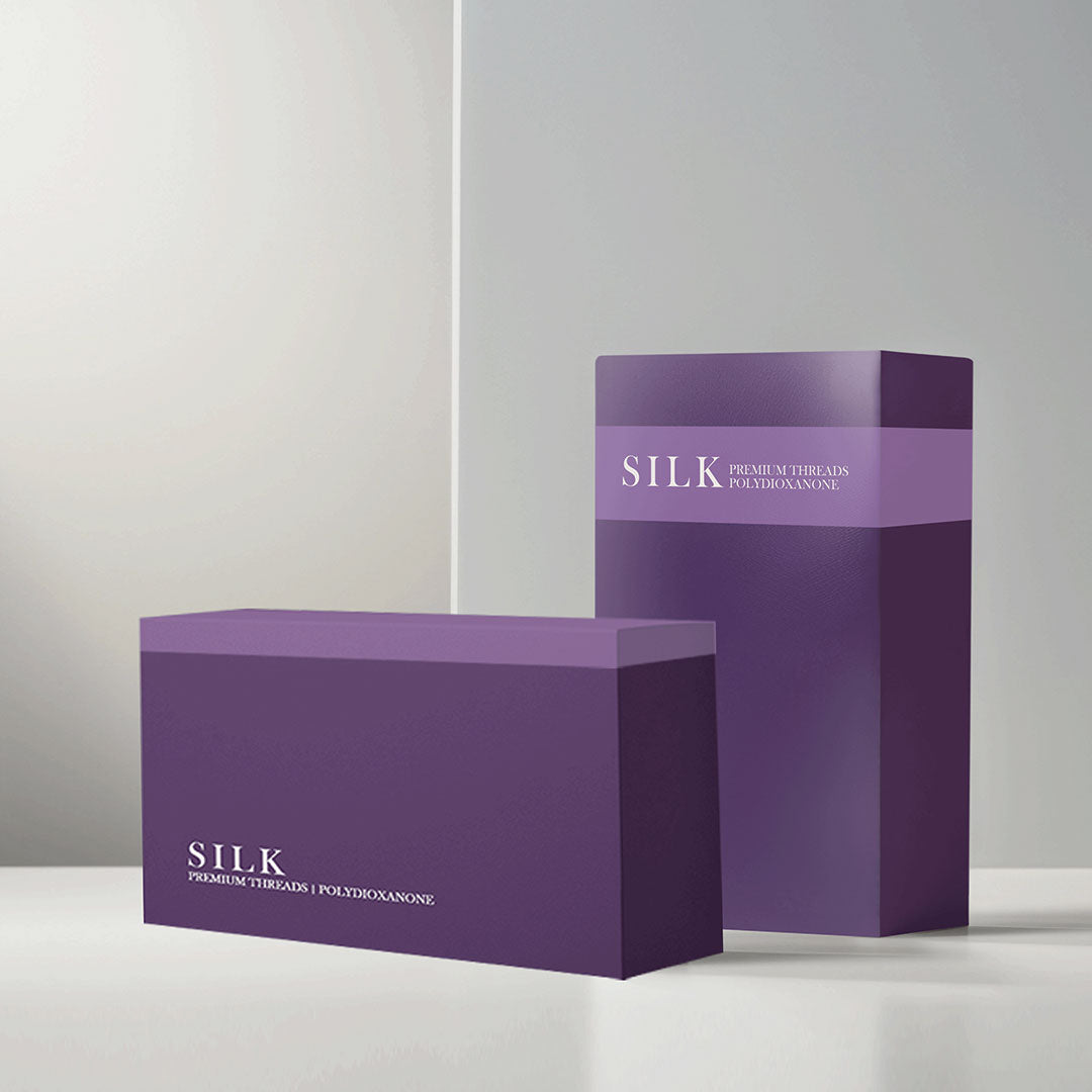 Two purple boxes of SILK PDO Premium Threads Polydioxanone packaging displayed on a clean white surface with a minimalist background