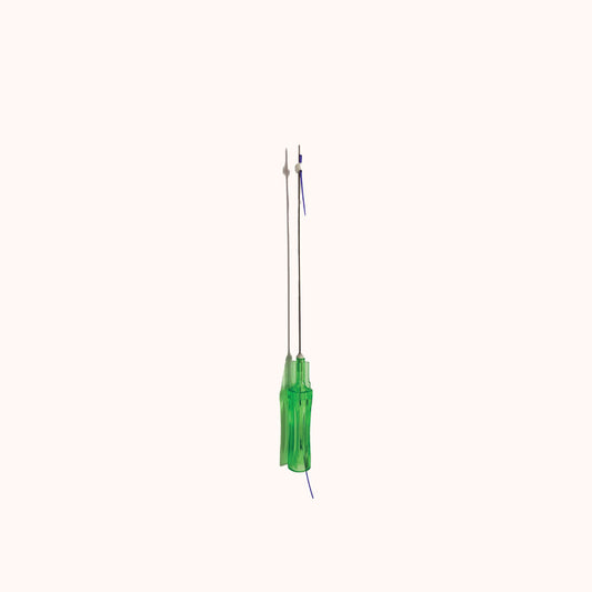 Close-up of a SILK PDO Lift Cog thread with a green handle, featuring two blunt-tip cannulas preloaded with fine purple threads for cosmetic lifting procedures